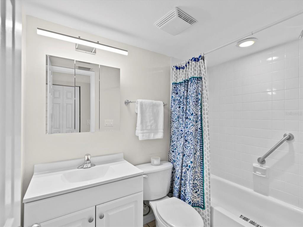 2737 Enterprise Road East, Unit 111 Clearwater, FL 33759 - Photo 14 of 28 a bathroom with a sink a toilet and shower