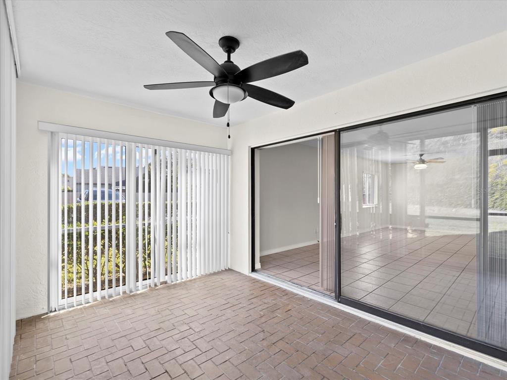 2737 Enterprise Road East, Unit 111 Clearwater, FL 33759 - Photo 16 of 28 en empty room with window and a ceiling fan