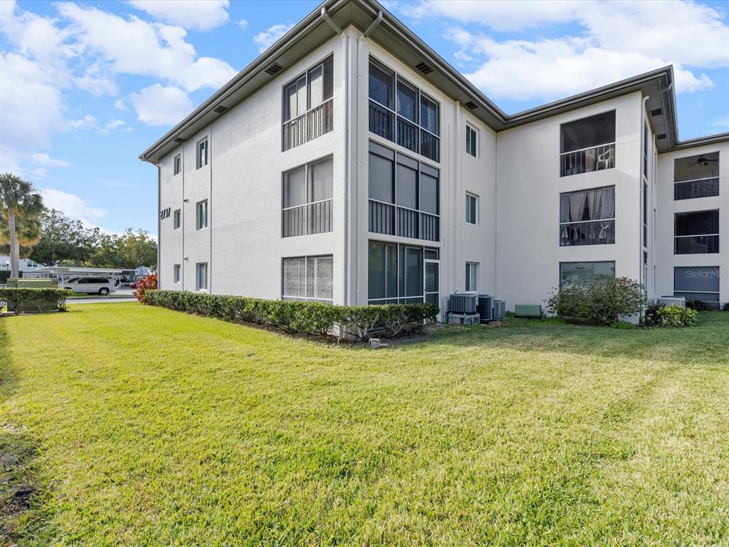 2737 Enterprise Road East, Unit 111 Clearwater, FL 33759 - Photo 23 of 28 a front view of a building with swimming pool