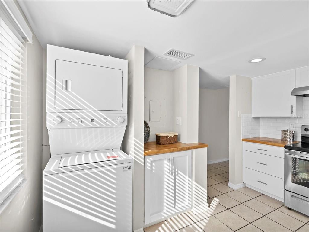 2737 Enterprise Road East, Unit 111 Clearwater, FL 33759 - Photo 8 of 28 a bedroom with a bed and a cabinets