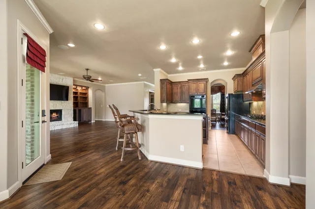 a view of a kitchen and dining room with wooden floor