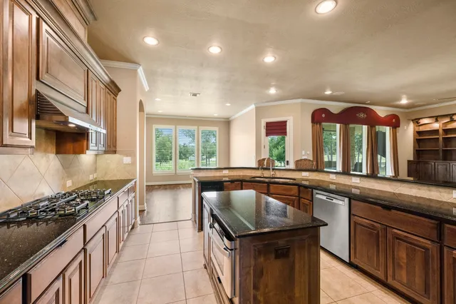 a kitchen with lots of counter top space and stainless steel appliances