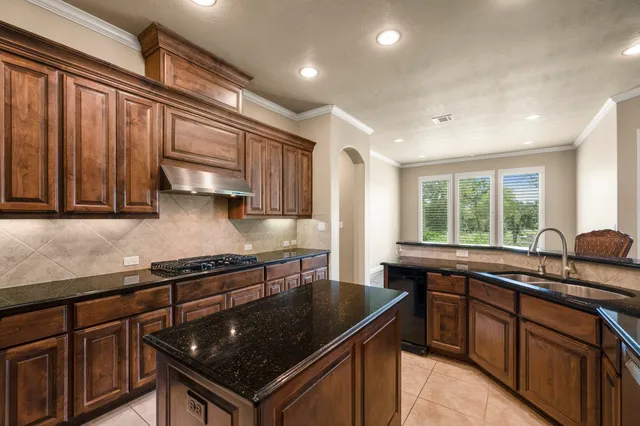 a kitchen with a sink stove and cabinets