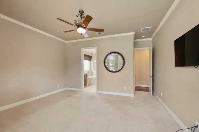 a view of a livingroom with a ceiling fan and wooden floor