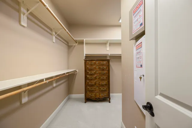 a view of walk in closet with clothes