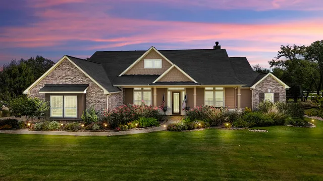 a front view of a house with swimming pool having outdoor seating