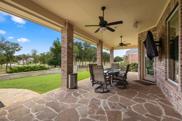 a view of a patio with a table chairs and backyard