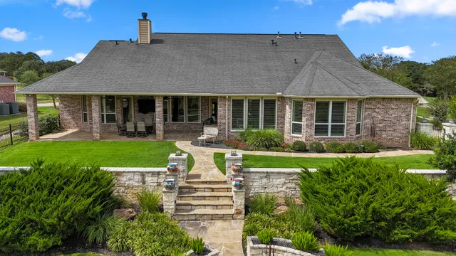 a view of a house with garden and a porch