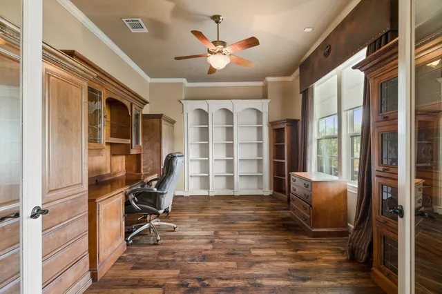 a view of a livingroom with wooden floor and furniture