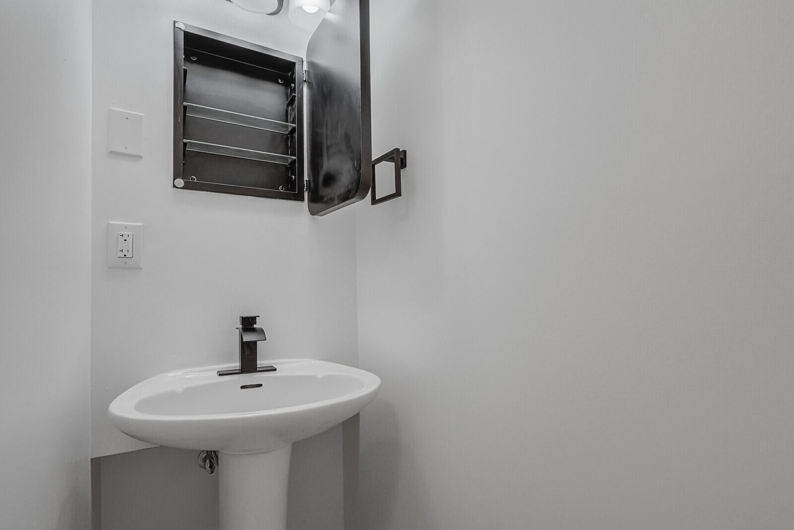 2929 Southeast Ocean Boulevard, Unit E1 Stuart, FL 34996 - Photo 24 of 37 a bathroom with a sink and mirror