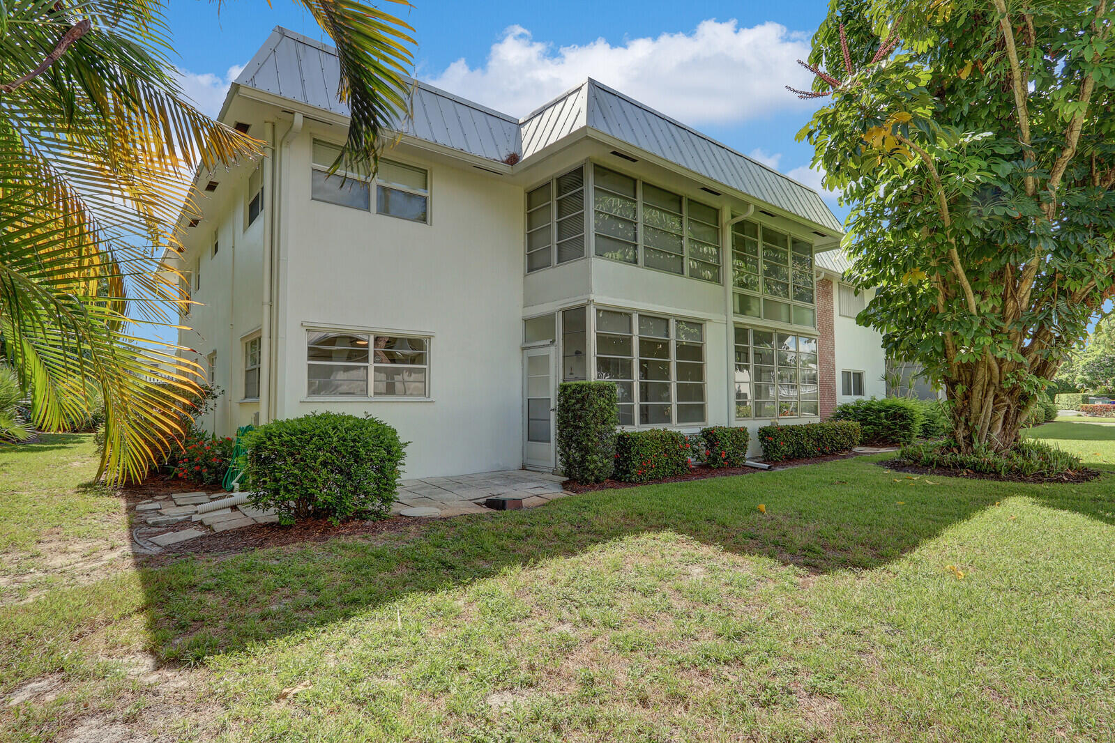 2929 Southeast Ocean Boulevard, Unit E1 Stuart, FL 34996 - Photo 32 of 37 front view of a house with a yard
