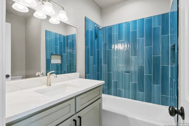 a bathroom with a sink a vanity and a mirror