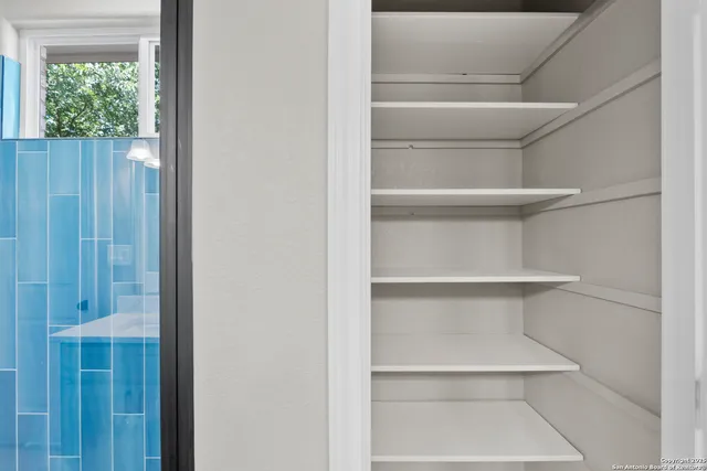 a view of walk in closet with empty racks