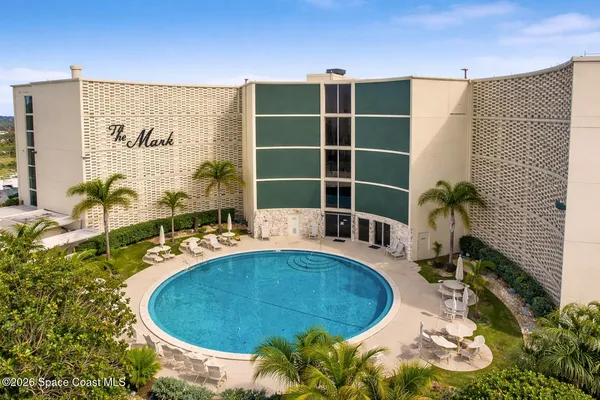 a view of a swimming pool with chairs