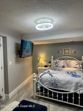 a view of a bedroom with furniture and window