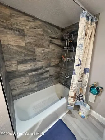 a bed sitting in a bedroom and table