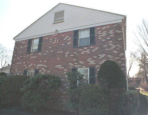 27 Maple Tree Avenue, Unit G Stamford, CT 06906 - Photo 1 of 1 a brick house with a small yard