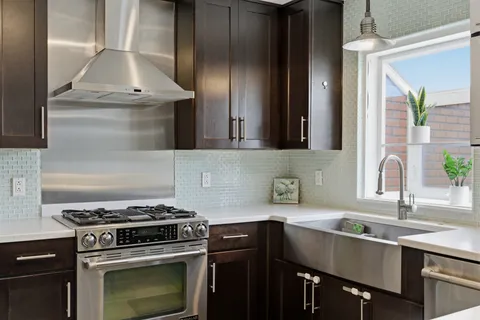 a kitchen with a sink stove and cabinets