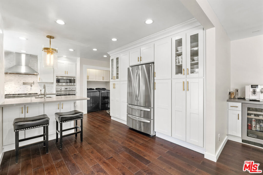 1823 Fern Lane Glendale, CA 91208 - Photo 12 of 30 a kitchen with kitchen island white cabinets and stainless steel appliances