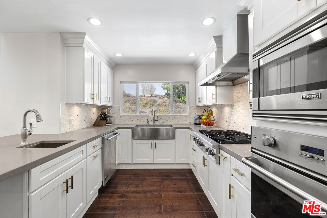1823 Fern Lane Glendale, CA 91208 - Photo 14 of 30 a kitchen with stainless steel appliances a sink stove and cabinets