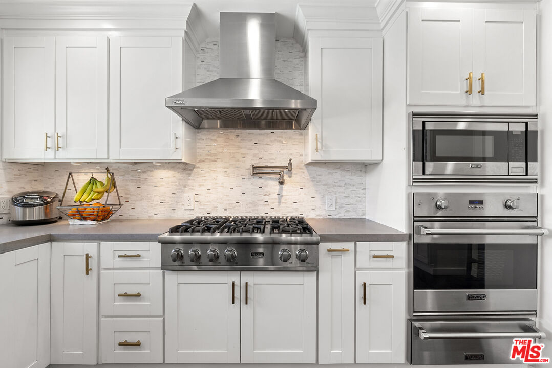 1823 Fern Lane Glendale, CA 91208 - Photo 15 of 30 a kitchen with stainless steel appliances granite countertop a stove a microwave and cabinets