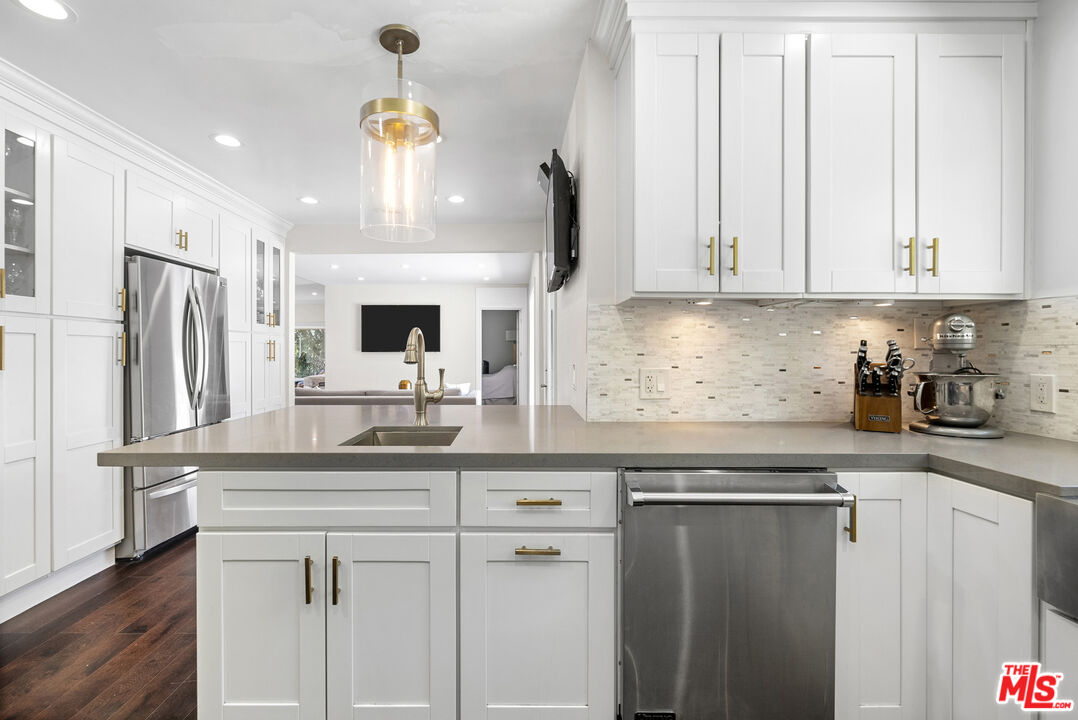 1823 Fern Lane Glendale, CA 91208 - Photo 16 of 30 a kitchen with stainless steel appliances a white cabinets and a chandelier