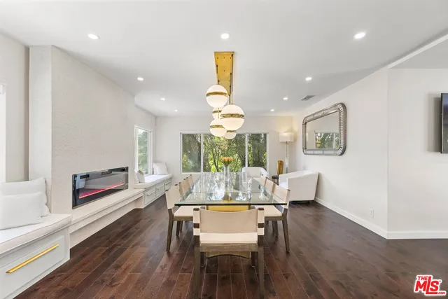 a view of a dining room with furniture a chandelier and wooden floor