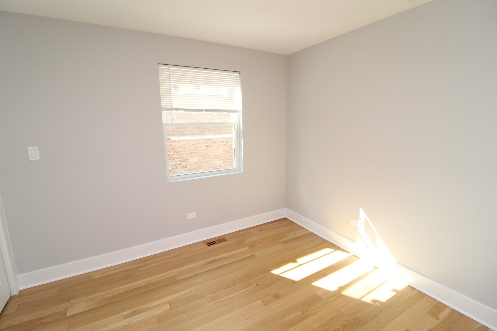 1411 West Taylor Street Chicago, IL 60607 - Photo 13 of 18 a view of an empty room with wooden floor and a window