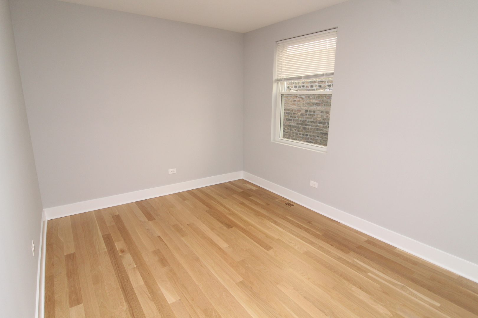 1411 West Taylor Street Chicago, IL 60607 - Photo 15 of 18 a view of an empty room with wooden floor and a window