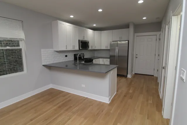 a kitchen with a sink stainless steel appliances and counter space