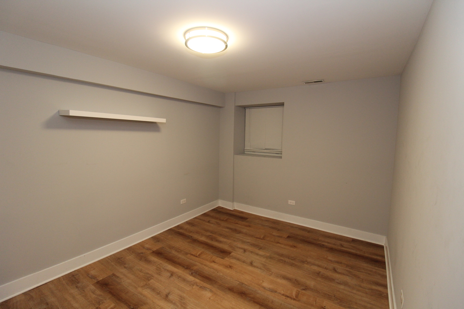 1411 West Taylor Street Chicago, IL 60607 - Photo 6 of 18 an empty room with wooden floor and windows