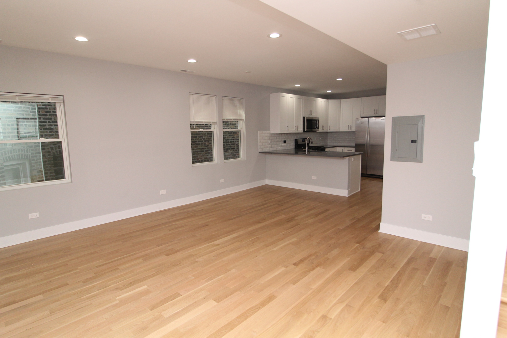 1411 West Taylor Street Chicago, IL 60607 - Photo 8 of 18 a view of kitchen with kitchen island granite countertop refrigerator oven and white cabinets