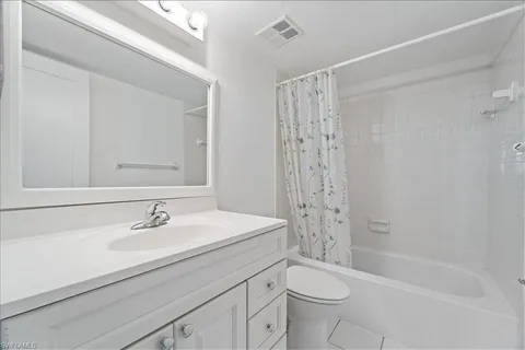 a bedroom with two beds and a window
