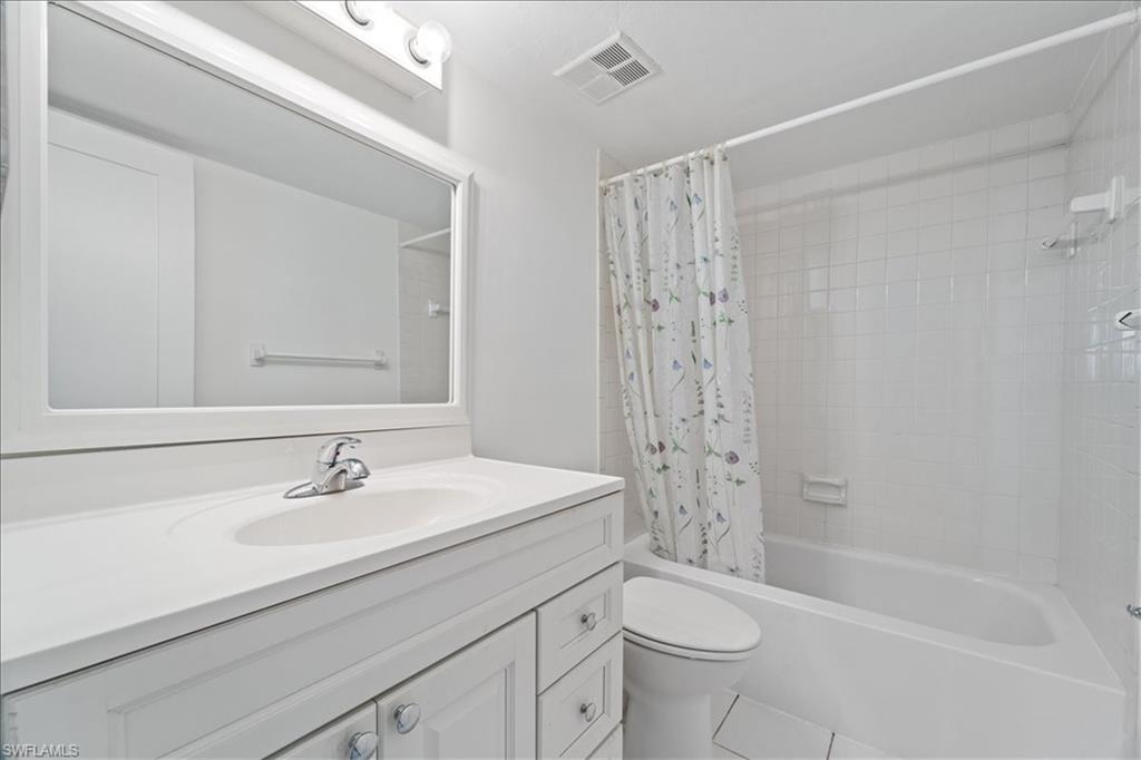 307 Goodlette-Frank Road, Unit B202 Naples, FL 34102 - Photo 17 of 32 a bathroom with a sink a toilet and shower