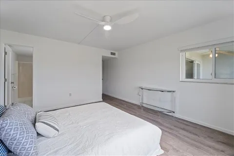 a bedroom with a bed and a night stand