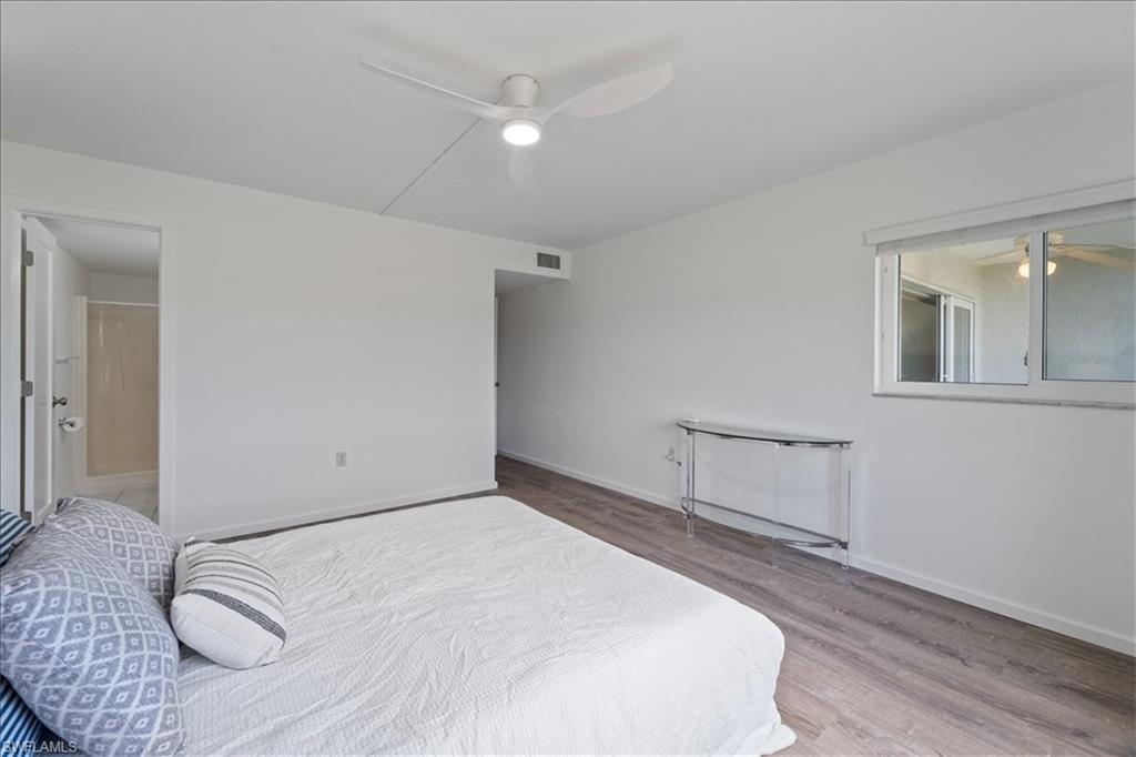 307 Goodlette-Frank Road, Unit B202 Naples, FL 34102 - Photo 20 of 32 a bedroom with a bed and a window