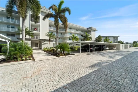 a front view of a building with a garden