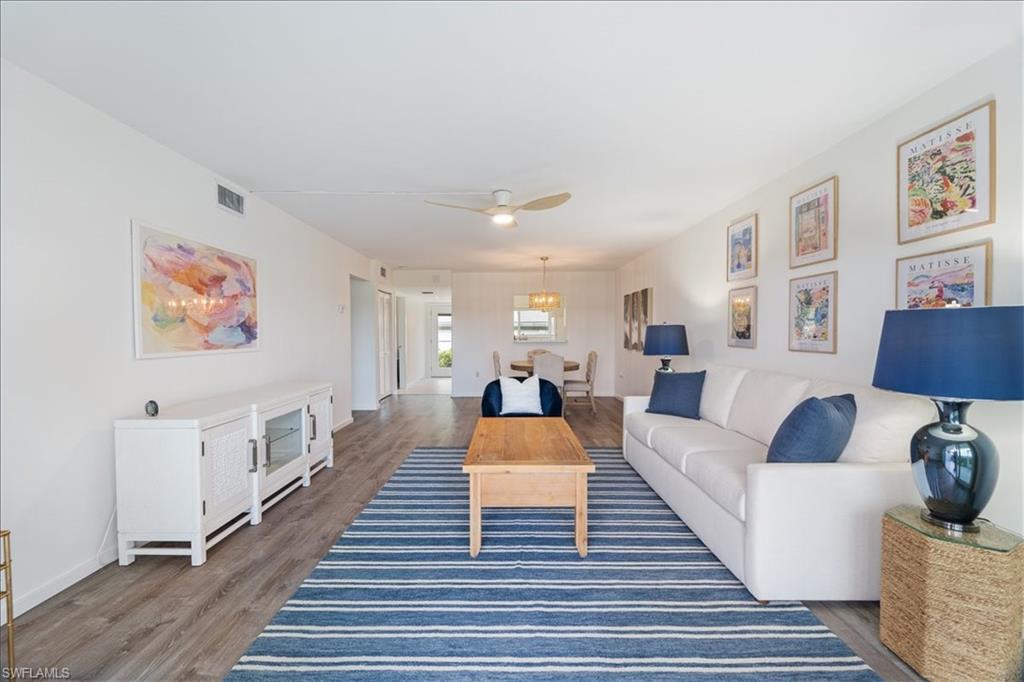 307 Goodlette-Frank Road, Unit B202 Naples, FL 34102 - Photo 26 of 32 a living room with furniture and a wooden floor