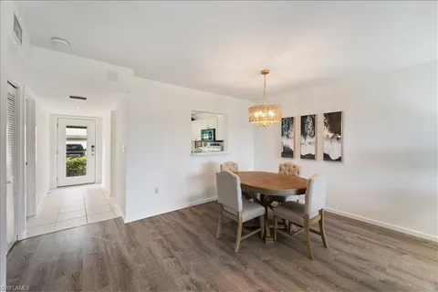 a kitchen with a refrigerator sink and cabinets