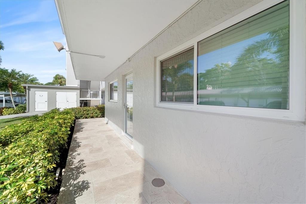 307 Goodlette-Frank Road, Unit B202 Naples, FL 34102 - Photo 32 of 32 a view of a house with a backyard