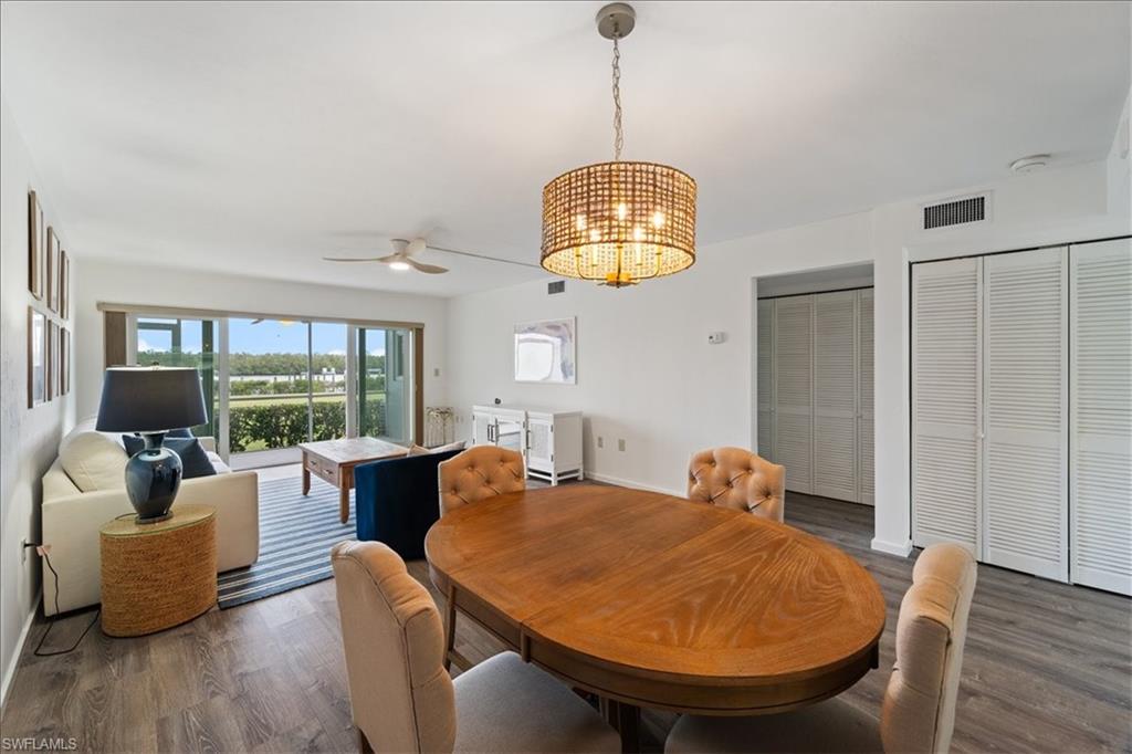 307 Goodlette-Frank Road, Unit B202 Naples, FL 34102 - Photo 6 of 32 a view of a dining room with furniture window and wooden floor