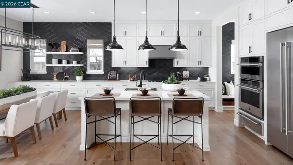 a living room with furniture white walls and a view of kitchen
