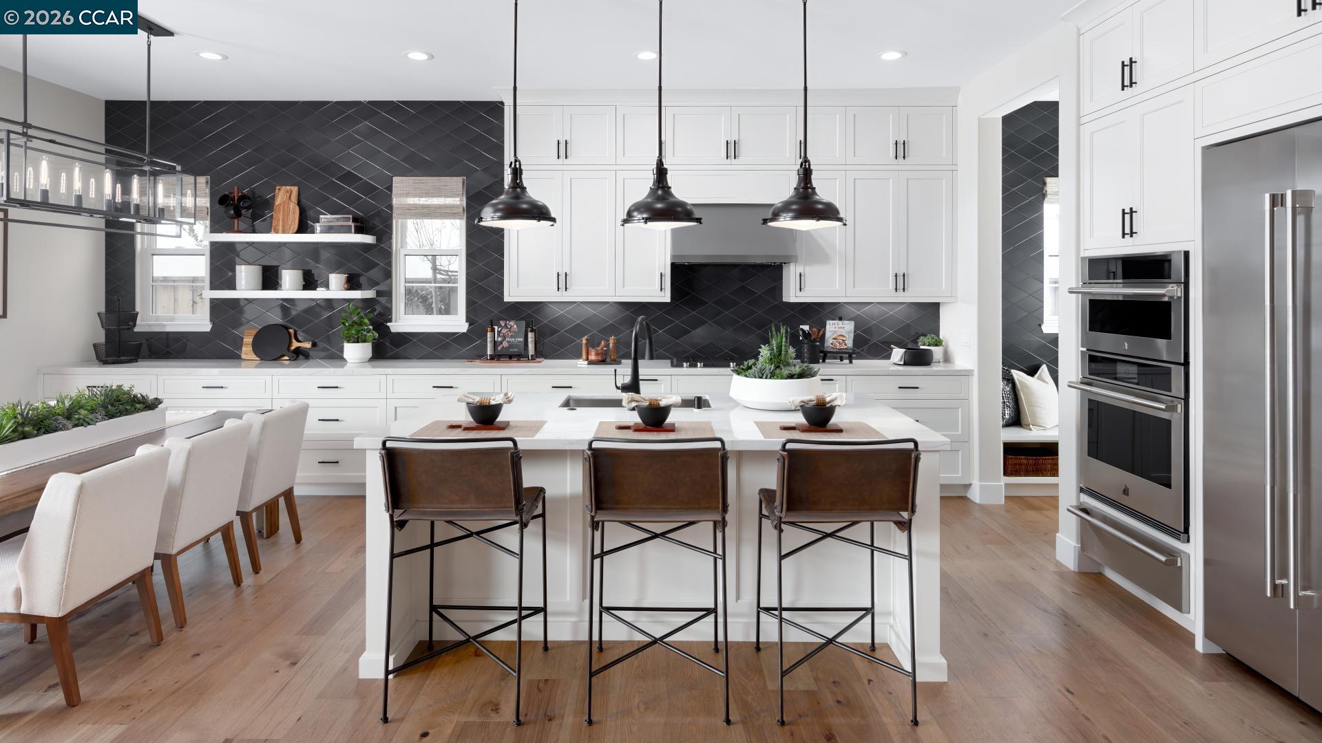 1885 Cascade Lane Tracy, CA 95377 - Photo 1 of 40 a dining room with stainless steel appliances kitchen island granite countertop a table chairs and a refrigerator