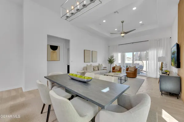 a view of a dining room with furniture and a chandelier
