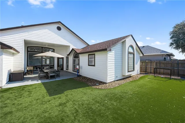 a view of a house with a yard and sitting area
