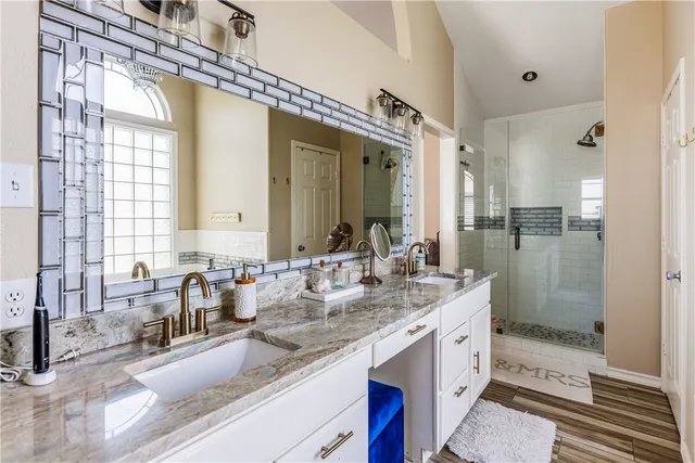 a bathroom with a granite countertop sink mirror and double
