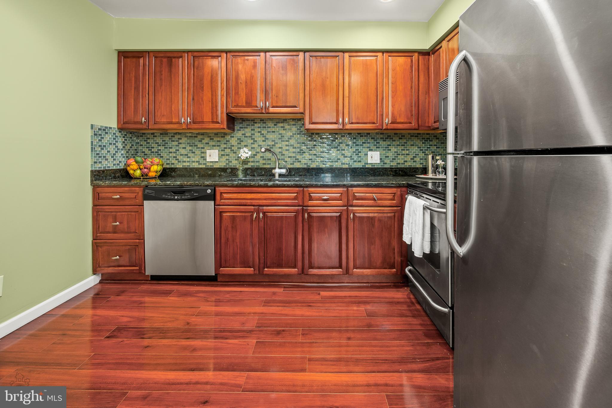 4000 Gypsy Lane, Unit 210 Philadelphia, PA 19129 - Photo 17 of 35 a view of a kitchen with stainless steel appliances wooden floor and a window