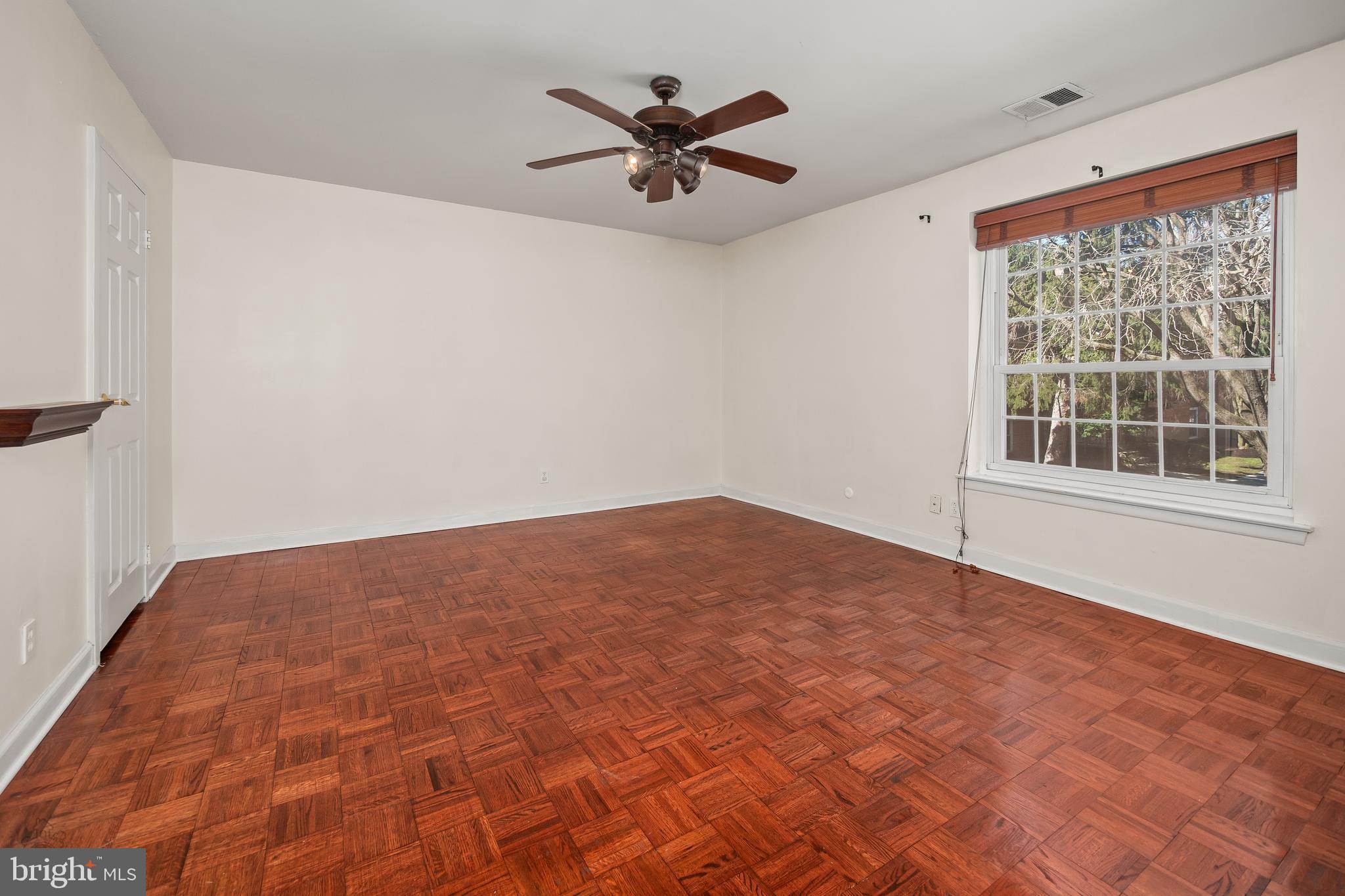 4000 Gypsy Lane, Unit 210 Philadelphia, PA 19129 - Photo 23 of 35 a view of empty room with wooden floor and fan