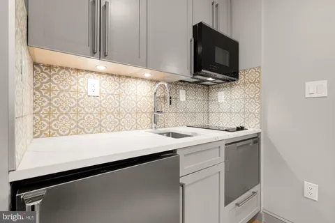a view of storage and utility room with a sink