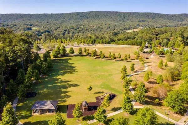 a view of a grassy field with trees in the background